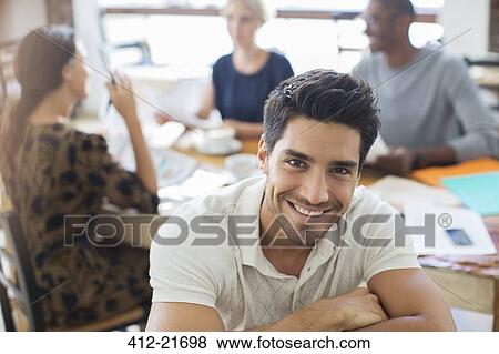 Businessman smiling at meeting in cafe View Large Photo Image Stock Photo - Businessman smiling at meeting in cafe. Fotosearch