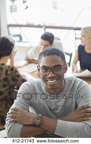 Stock Image - Businessman smiling in cafe. Fotosearch