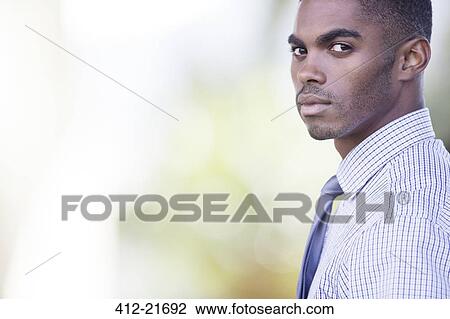 Stock Image - Businessman standing outdoors. Fotosearch