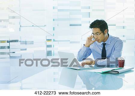 Businessman working on laptop at desk View Large Photo Image Stock Image - Businessman working on laptop at desk . Fotosearch