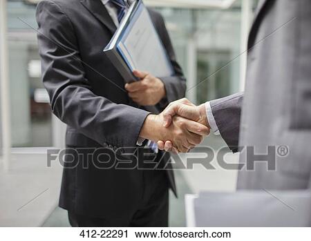 Businessmen shaking hands outdoors View Large Photo Image Stock Image - Businessmen shaking hands outdoors. Fotosearch