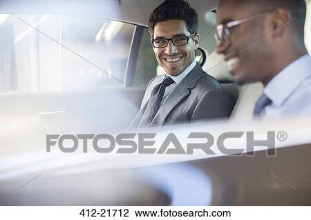 Businessmen sitting in car back seat View Large Photo Image Stock Image - Businessmen sitting in car back seat. Fotosearch