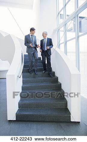 Businessmen talking on stairs View Large Photo Image Stock Image - Businessmen talking on stairs. Fotosearch