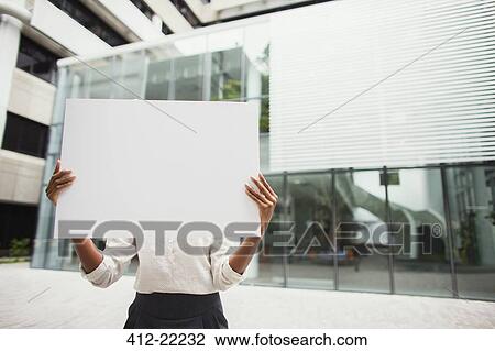 Businesswoman holding cardboard outside of office building View Large Photo Image Stock Image - Businesswoman holding cardboard outside of office building. Fotosearch