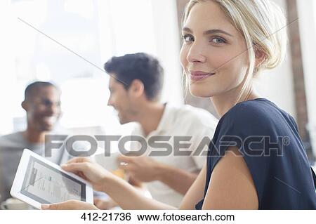 Businesswoman using digital tablet at meeting View Large Photo Image Stock Photograph - Businesswoman using digital tablet at meeting. Fotosearch