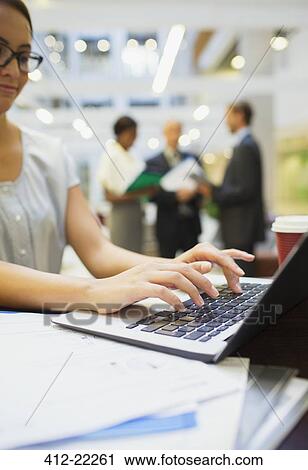 Businesswoman working on laptop in office building View Large Photo Image Stock Image - Businesswoman working on laptop in office building. Fotosearch