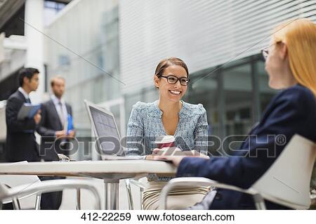 Businesswomen talking outside of office building View Large Photo Image Stock Photo - Businesswomen talking outside of office building. Fotosearch