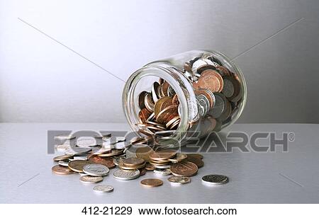 Change spilling out of glass jar on counter View Large Photo Image Stock Photo - Change spilling out of glass jar on counter. Fotosearch