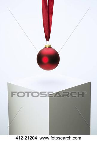 Christmas ornament hanging from ribbon over pedestal View Large Photo Image Picture - Christmas ornament hanging from ribbon over pedestal. Fotosearch