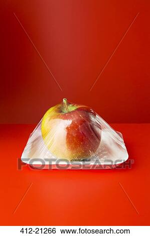 Close up of apple shrink wrapped in plastic View Large Photo Image Stock Photograph - Close up of apple shrink wrapped in plastic. Fotosearch
