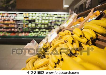 Close up of bananas in produce section of grocery store View Large Photo Image Stock Image - Close up of bananas in produce section of grocery store. Fotosearch