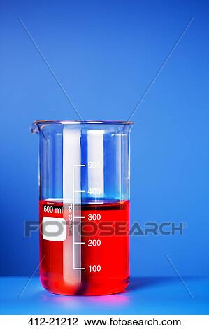 Stock Image - Close up of beaker of solution on blue counter. Fotosearch