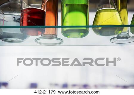Close up of beakers with solution on shelf in lab View Large Photo Image Stock Photo - Close up of beakers with solution on shelf in lab. Fotosearch