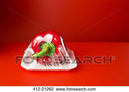 Stock Image - Close up of bell pepper shrink wrapped in plastic. Fotosearch