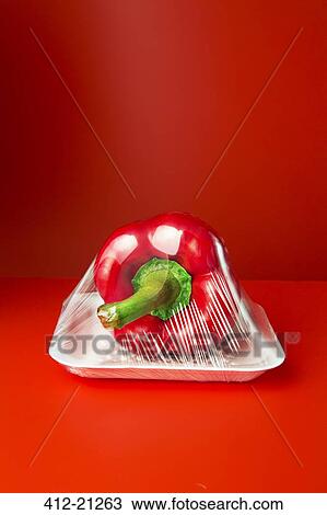 Stock Image - Close up of bell pepper shrink wrapped in plastic. Fotosearch