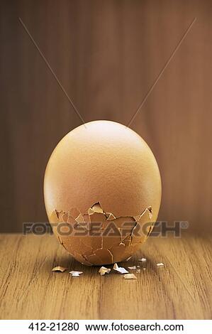 Stock Image - Close up of egg cracking on counter. Fotosearch
