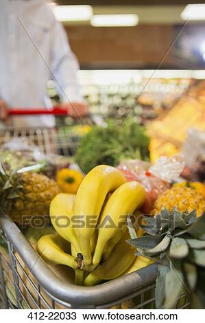 Close up of full shopping cart in grocery store View Large Photo Image Stock Image - Close up of full shopping cart in grocery store. Fotosearch