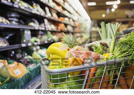Close up of full shopping cart in grocery store View Large Photo Image Stock Photography - Close up of full shopping cart in grocery store. Fotosearch