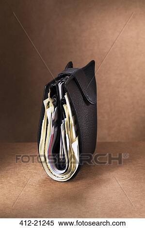 Close up of full wallet standing upright on counter View Large Photo Image Stock Photography - Close up of full wallet standing upright on counter. Fotosearch