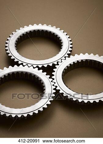 Stock Image - Close up of interlocking metal gears. Fotosearch