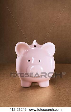 Stock Photograph - Close up of piggy bank on counter. Fotosearch