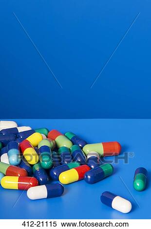 Close up of pile of prescription pills on blue background View Large Photo Image Stock Photography - Close up of pile of prescription pills on blue background. Fotosearch