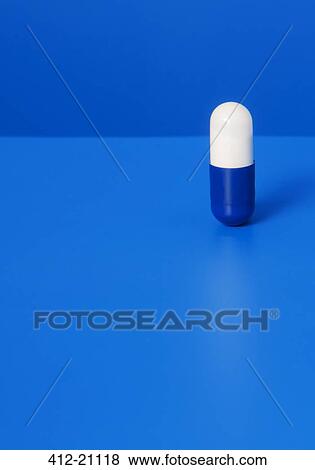 Close up of prescription pill on blue background View Large Photo Image Stock Photo - Close up of prescription pill on blue background. Fotosearch