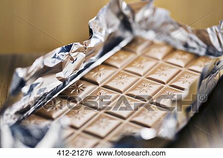 Close up of unwrapped bar of chocolate View Large Photo Image Stock Photograph - Close up of unwrapped bar of chocolate. Fotosearch