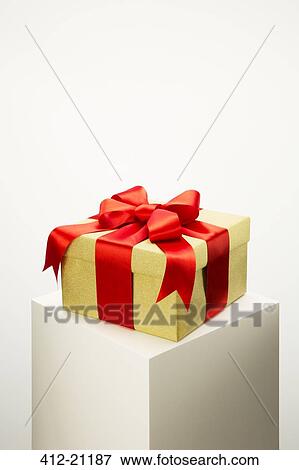Close up of wrapped gift on pedestal View Large Photo Image Stock Photo - Close up of wrapped gift on pedestal. Fotosearch