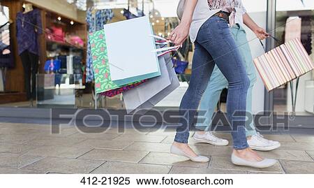 Couple carrying shopping bags on shopping mall View Large Photo Image Stock Photography - Couple carrying shopping bags on shopping mall. Fotosearch