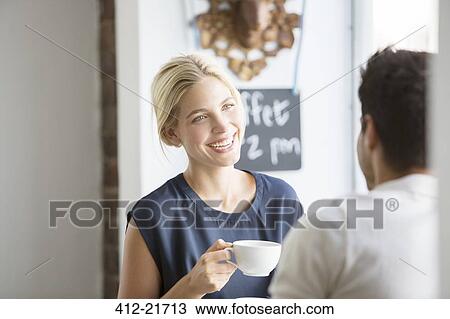 Couple having coffee together in cafe View Large Photo Image Stock Image - Couple having coffee together in cafe. Fotosearch
