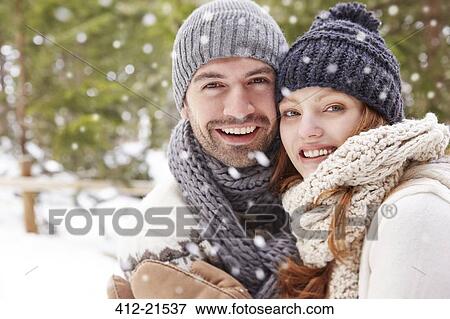 Couple hugging in snow View Large Photo Image Stock Photo - Couple hugging in snow. Fotosearch