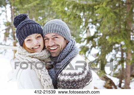 Couple hugging in snow View Large Photo Image Stock Photo - Couple hugging in snow. Fotosearch