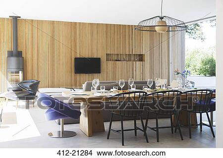 Picture - Dining table, sofas and television in open living room and dining room. Fotosearch