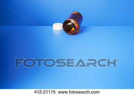 Empty pill bottle open on blue counter View Large Photo Image Stock Photography - Empty pill bottle open on blue counter. Fotosearch