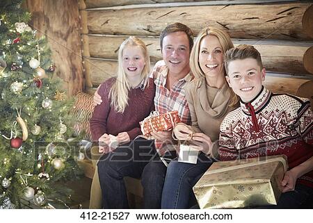 Family opening gifts on Christmas View Large Photo Image Stock Photo - Family opening gifts on Christmas. Fotosearch