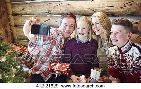 Family taking picture together on Christmas View Large Photo Image Stock Photo - Family taking picture together on Christmas. Fotosearch