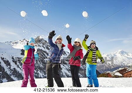 Family throwing snowballs on mountain top View Large Photo Image Stock Photograph - Family throwing snowballs on mountain top. Fotosearch