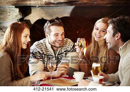 Stock Image - Friends enjoying drinks together. Fotosearch