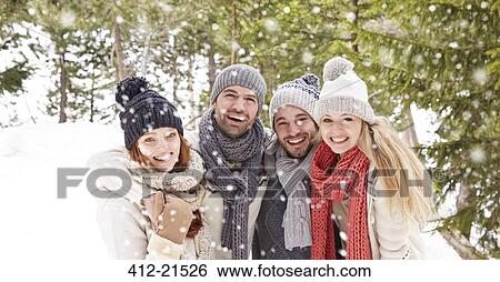 Friends hugging in the snow View Large Photo Image Stock Photograph - Friends hugging in the snow . Fotosearch