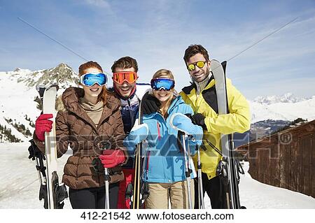 Friends on mountain top holding skis together View Large Photo Image Stock Image - Friends on mountain top holding skis together . Fotosearch