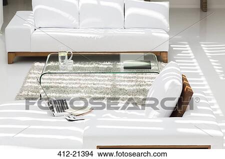 Laptop, sofas and coffee table in modern living room View Large Photo Image Picture - Laptop, sofas and coffee table in modern living room. Fotosearch