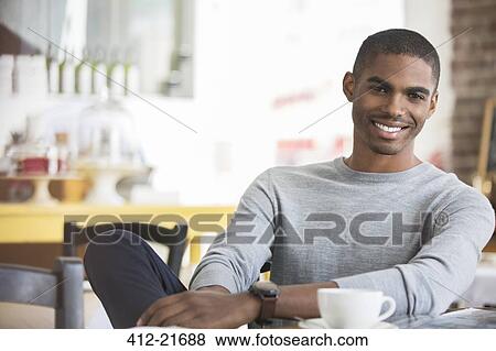 Man having coffee in cafe View Large Photo Image Stock Photo - Man having coffee in cafe. Fotosearch