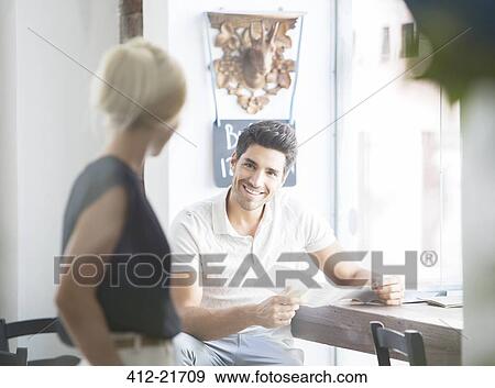 Man ordering from waitress talking in cafe View Large Photo Image Stock Photo - Man ordering from waitress talking in cafe . Fotosearch
