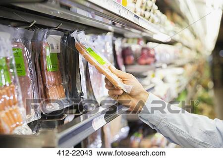 Man selecting product in grocery store View Large Photo Image Stock Image - Man selecting product in grocery store. Fotosearch