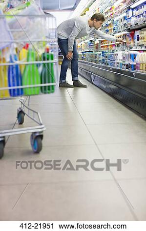 Man shopping in grocery store View Large Photo Image Stock Image - Man shopping in grocery store. Fotosearch