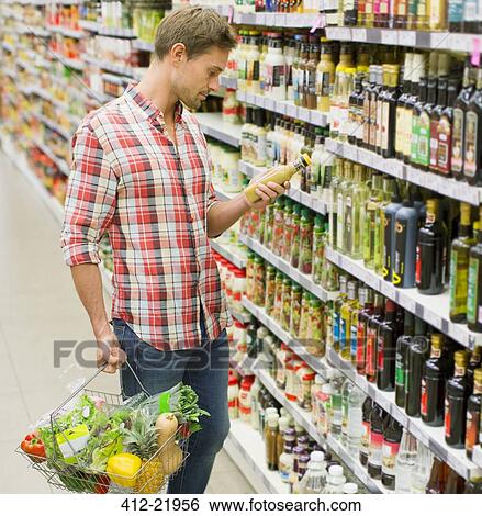 Stock Photograph - Man shopping in grocery store. Fotosearch