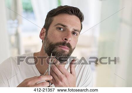 Man trimming beard in bathroom View Large Photo Image Stock Photo - Man trimming beard in bathroom. Fotosearch