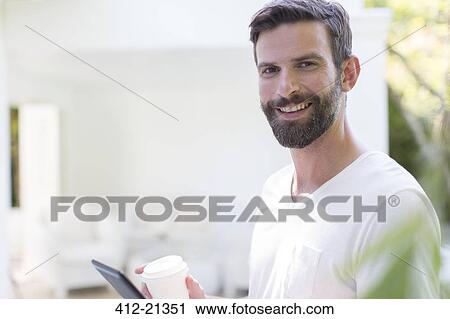 Man using digital tablet outdoors View Large Photo Image Stock Image - Man using digital tablet outdoors. Fotosearch