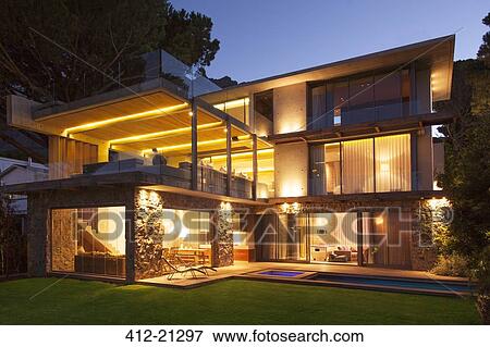 Modern house illuminated at night View Large Photo Image Stock Photo - Modern house illuminated at night. Fotosearch